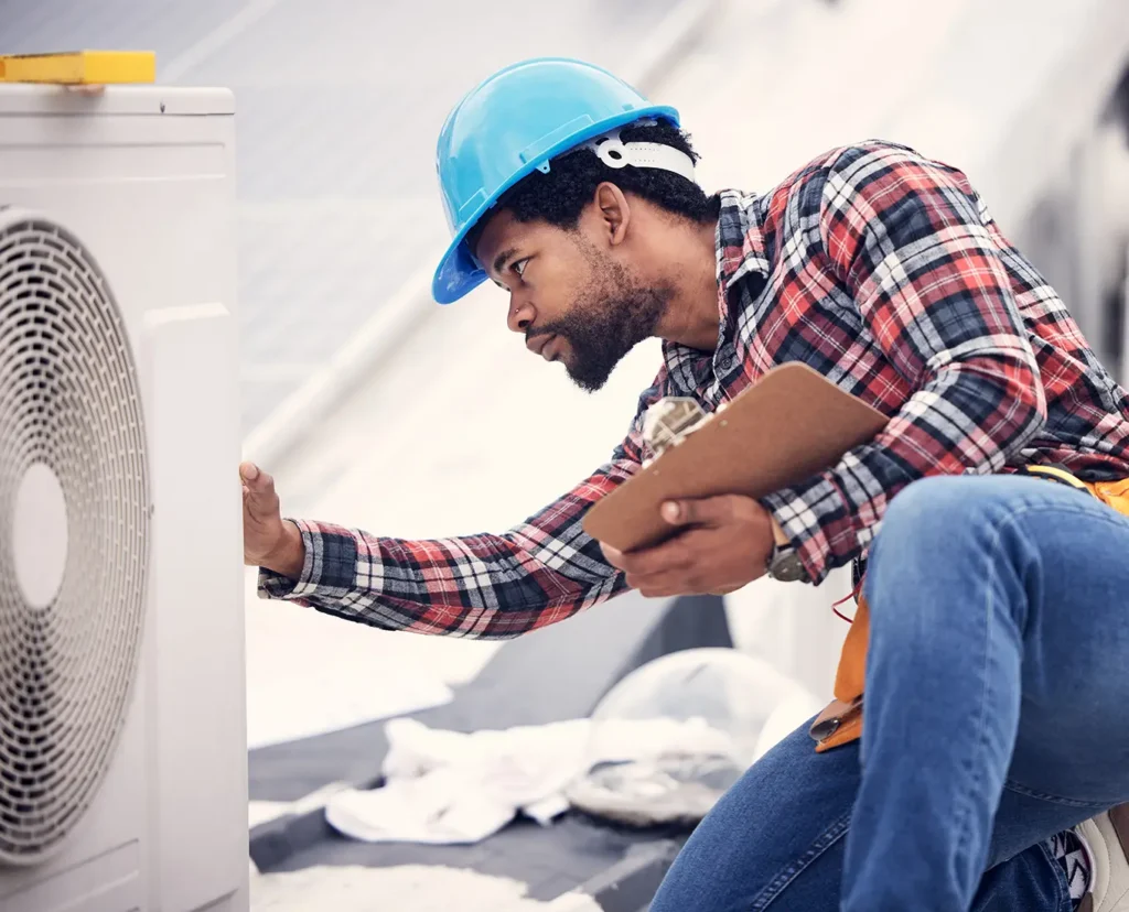 Premier Heating & Air HVAC Technician inspecting air conditioning unit in springfield il