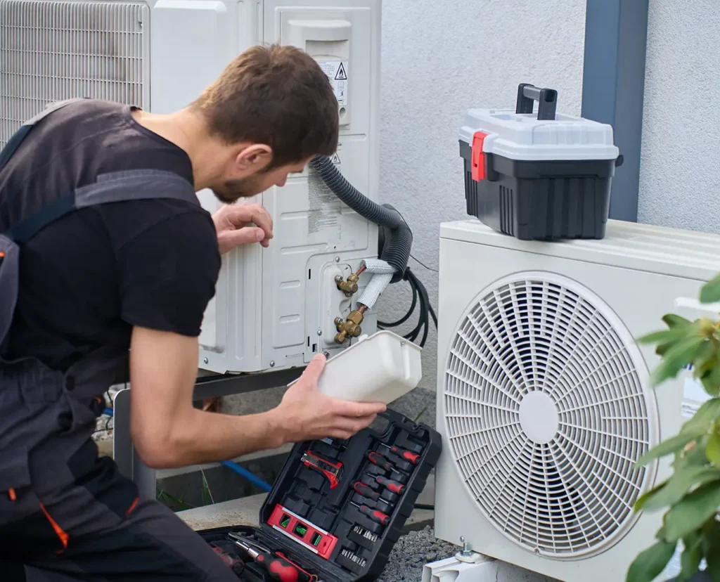 Premier Heating & Air HVAC Technician working on a heat pump in Springfield, IL