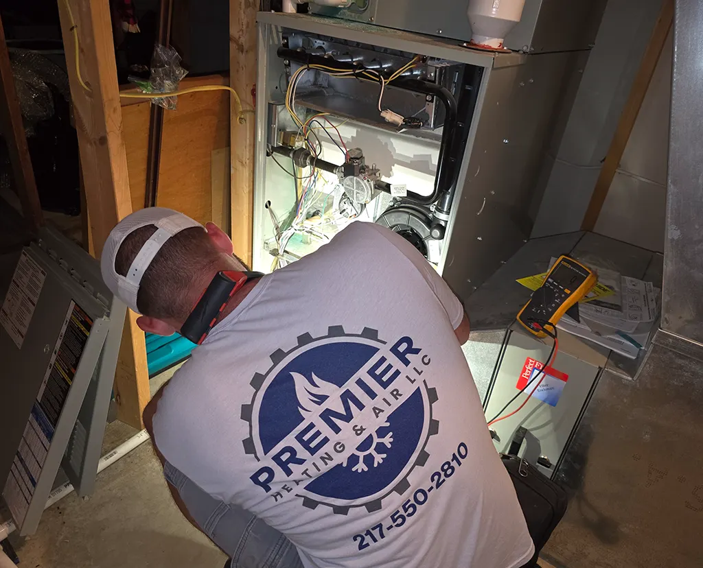 Premier Heating & Air HVAC Technician installing new Furnace for Home in springfield il
